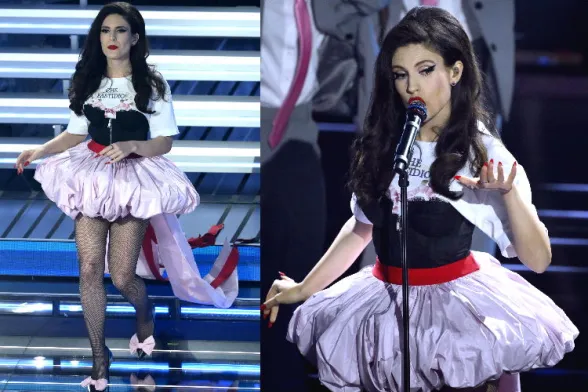 Dito nella Piaga: il suo stile non è mai neutro: o lo ami o ti spiazza. In questo outfit il concept prevale sulla figura: l’abito comunica un’idea forte, ma non  valorizza il corpo e la presenza scenica. Roberta D’Olimpio x Al Pacinoe 0